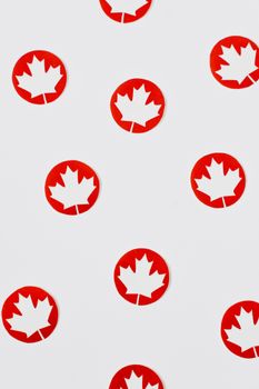 Pattern of red maple leaf symbols representing Canada on a white backdrop.