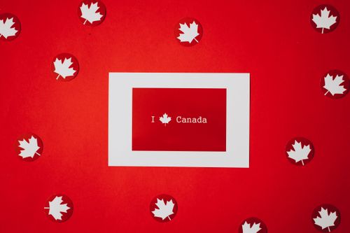 Free Red and white Canadian flag theme with maple leaves celebrating Canada Day. Stock Photo