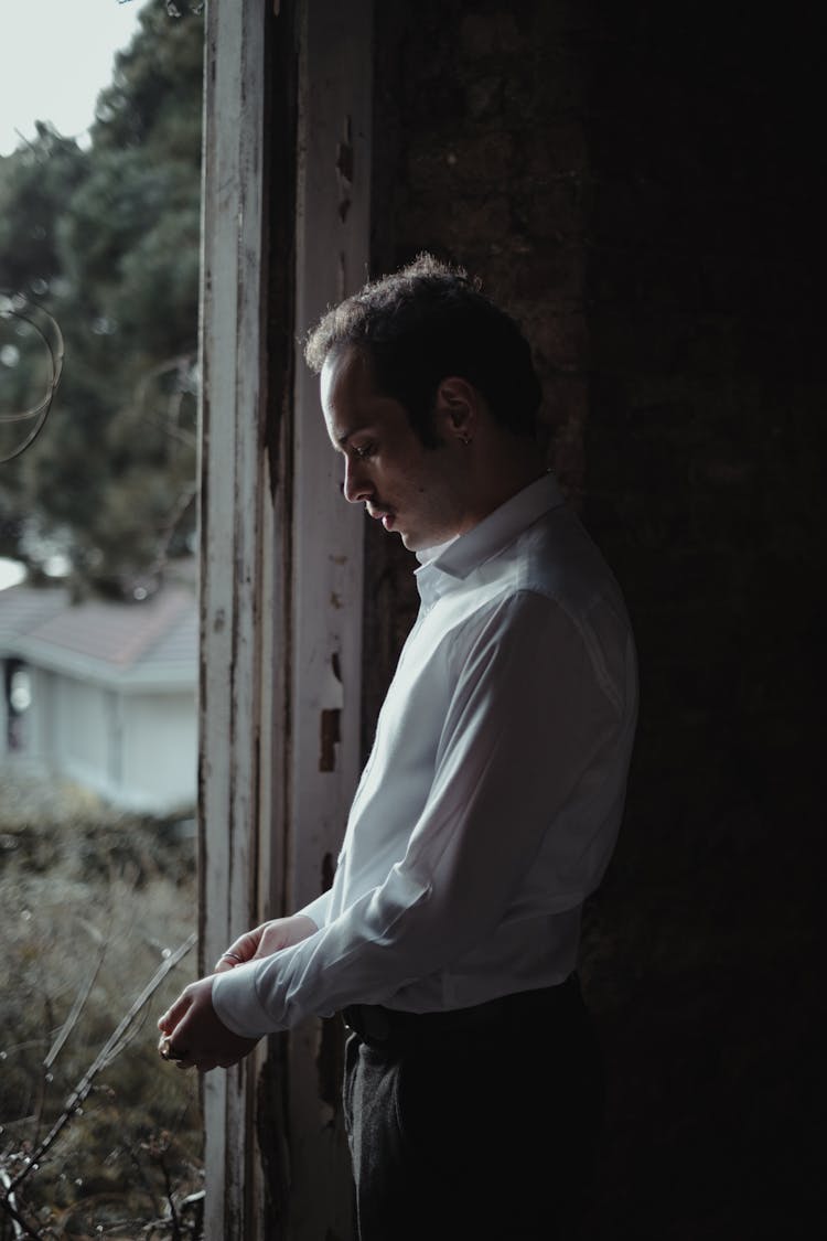 Serious Man In Doorway Of Shabby House