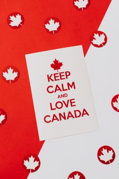 A conceptual poster with a 'Keep Calm and Love Canada' message, decorated with red maple leaves on a red and white background.