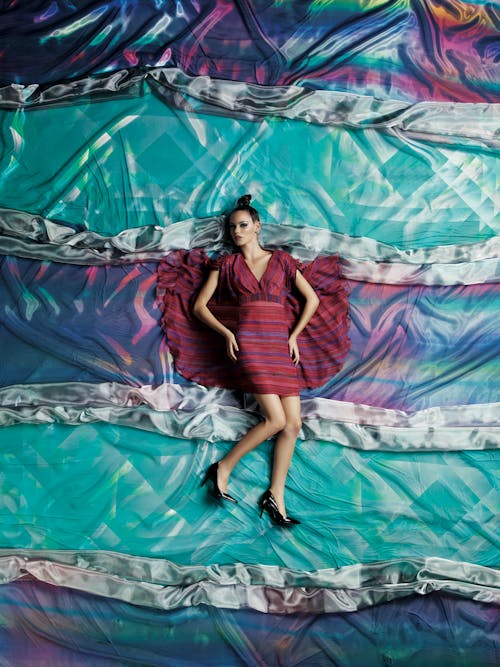 Photo of Woman Laying on Fabric