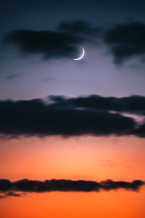 Crescent Moon Hiding in Layers of Dark Clouds