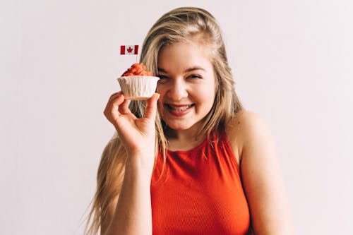 Smiling Woman Holding a Cupcake