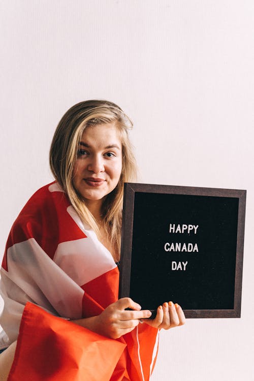 Free Photo of Woman wrapped with Candian Flag Stock Photo