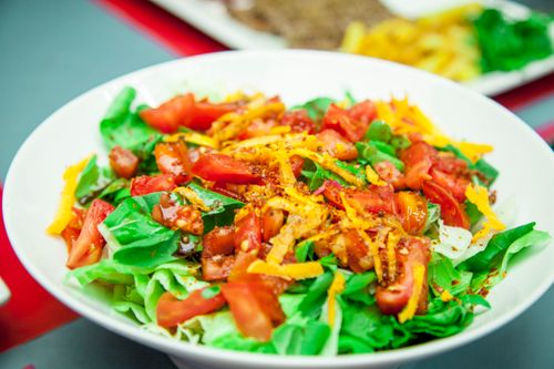 Free Colorful salad with tomatoes, lettuce, and carrots, showcasing fresh ingredients. Stock Photo