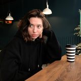 Portrait in a dark teal cafe, photo by Valeri Mak on Pexels