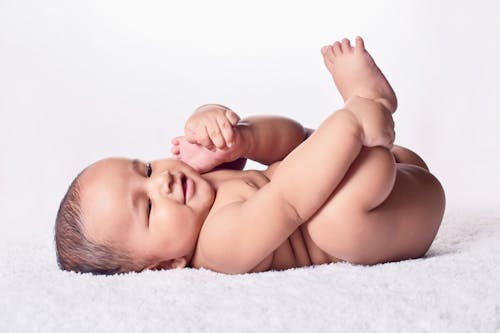 Free A Naked Baby Lying Down Stock Photo