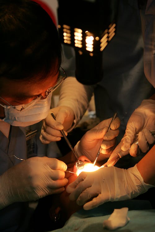 Free Medical Practitioners doing a Surgery  Stock Photo