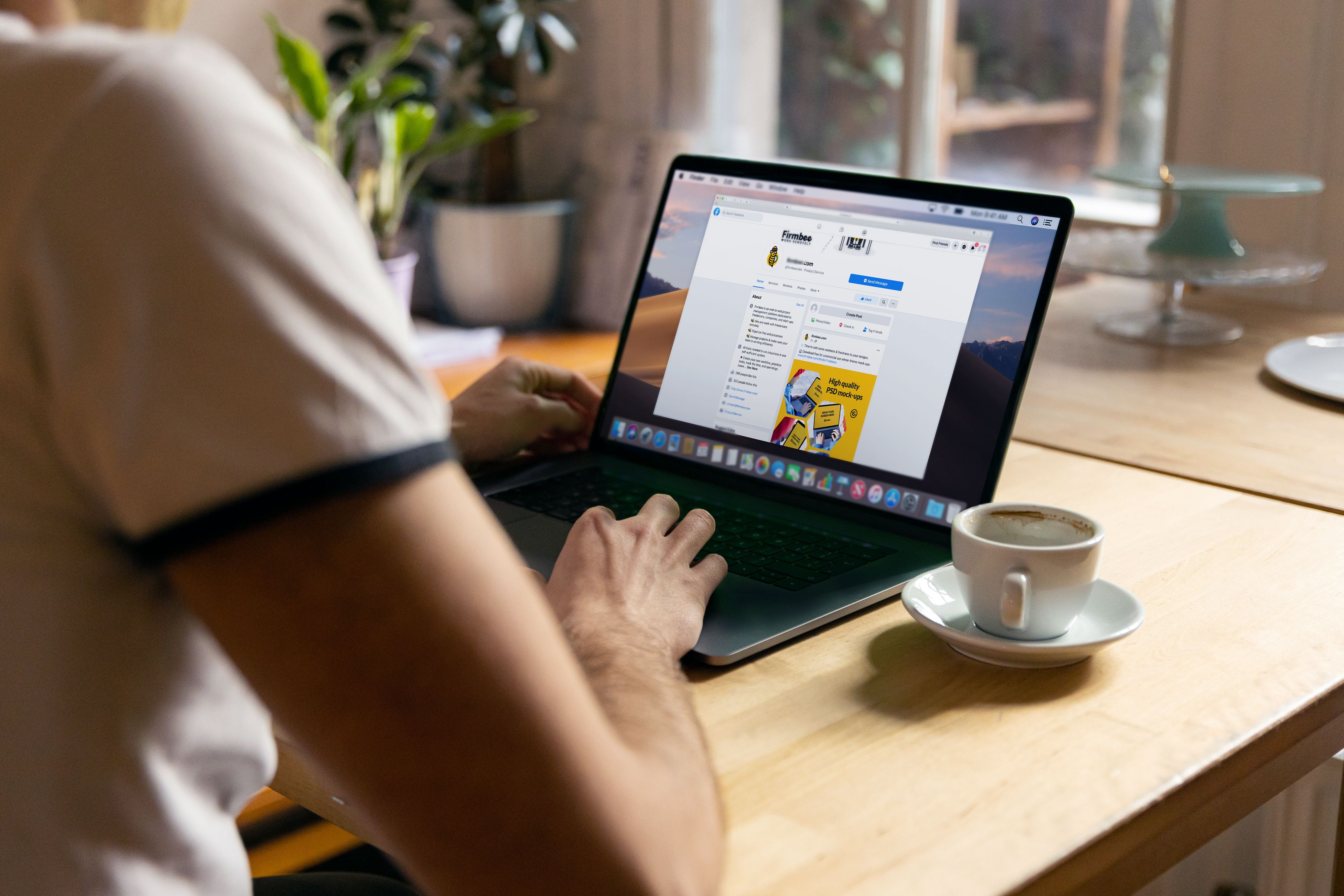 Casual home office setup with a person browsing the internet on a laptop next to a cup of coffee.