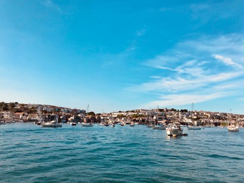 Free A vibrant harbor filled with sailboats under a clear blue sky, capturing a serene coastal scene. Stock Photo