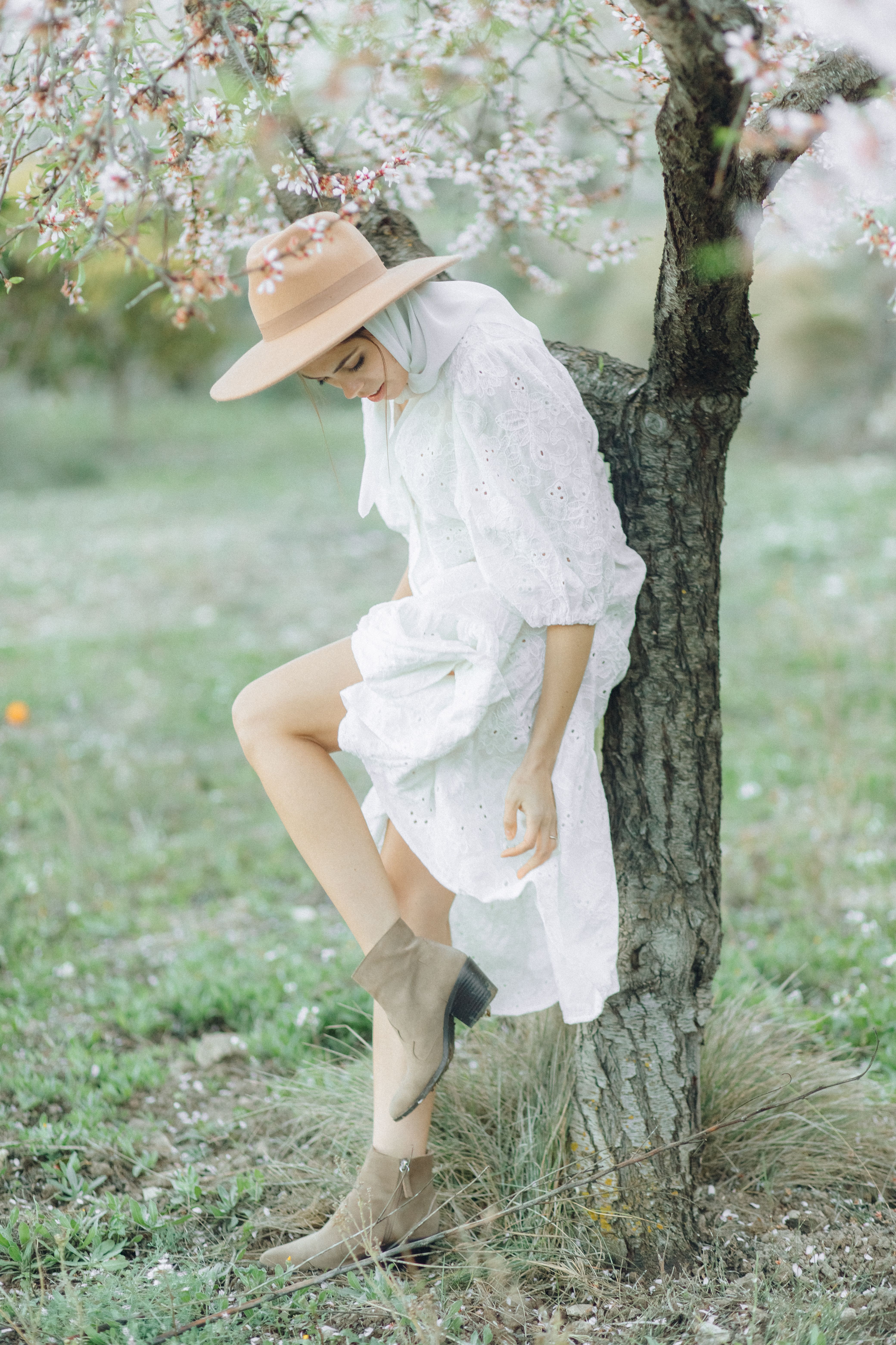 Woman in White Dress and Brown Hat Leaning on Tree · Free Stock Photo