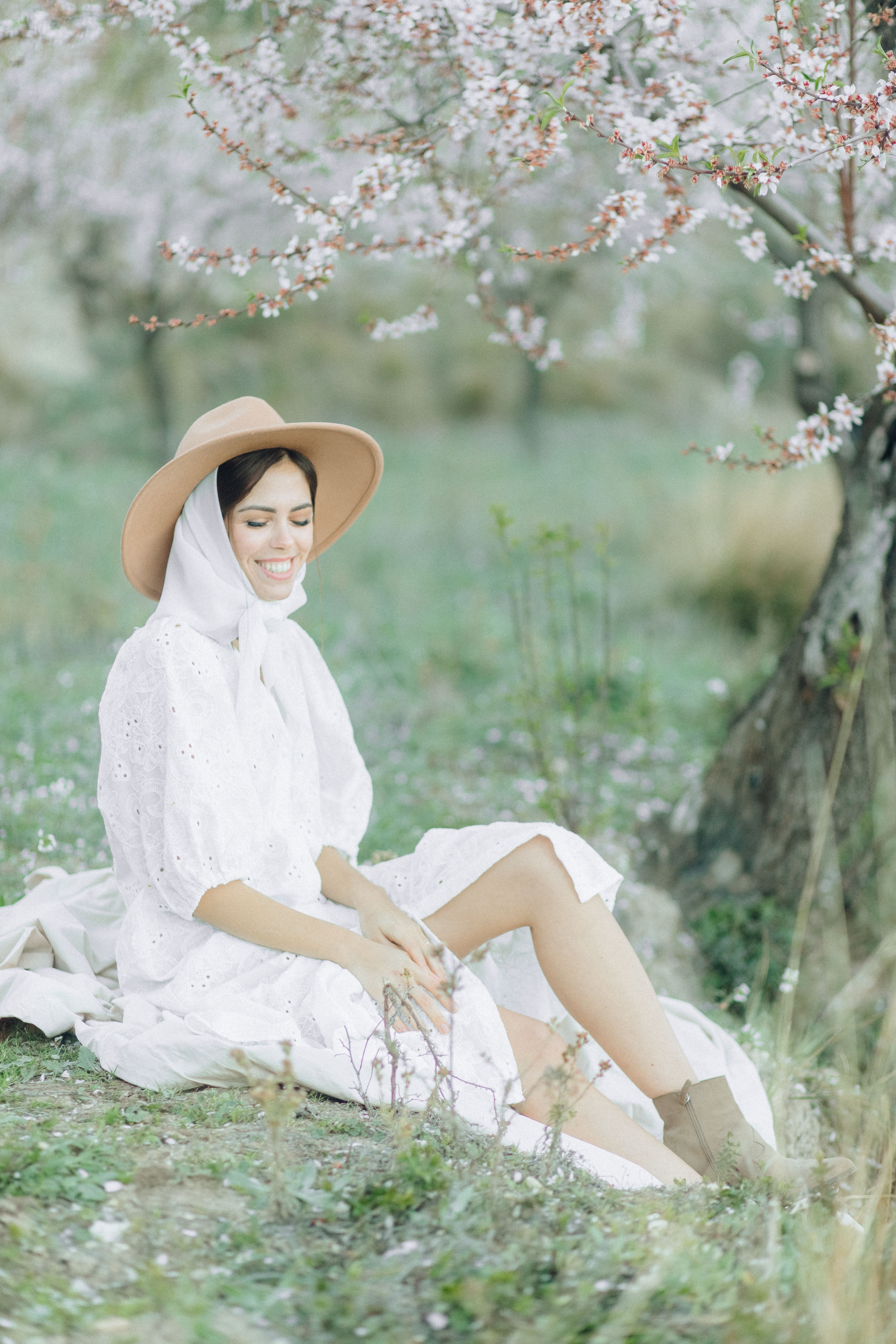 Woman in White Dress Wearing Sitting on Grass · Free Stock Photo