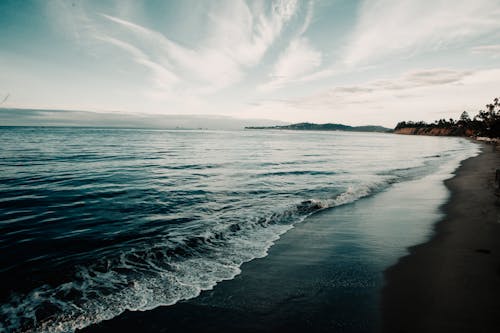 Shoreline Under Blue Sky