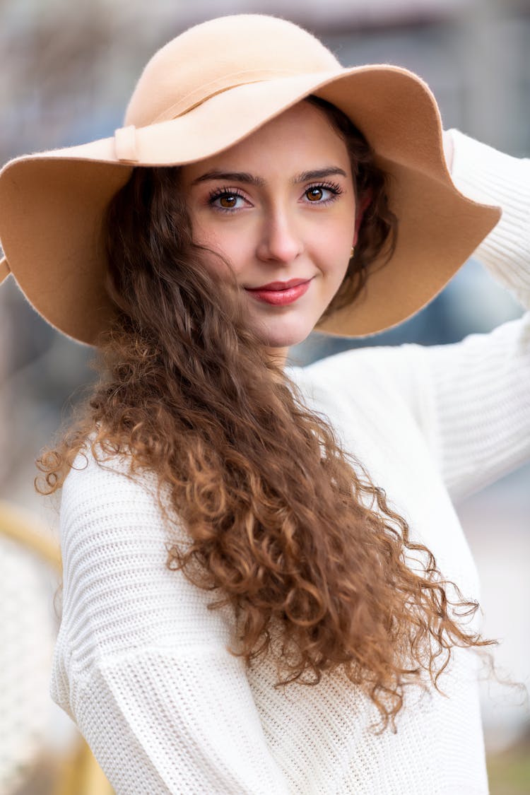 Curly Haired Woman Wearing Beige Hat 