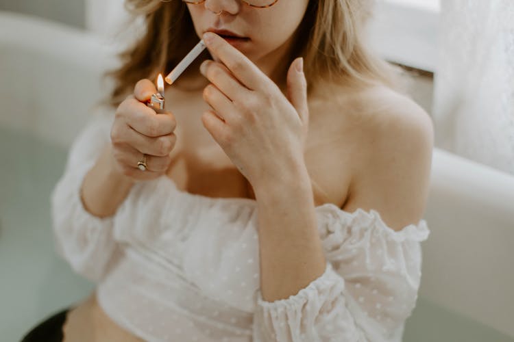 A Woman Lighting A Cigarette