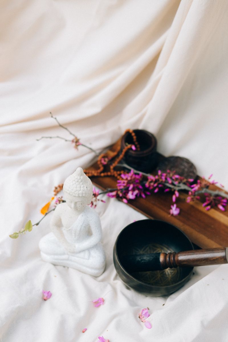 Calm studio corner with Buddha statue, singing bowl and flowers