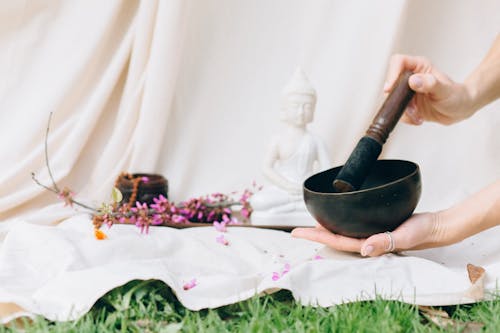 Close-Up Shot of a Person Holding a Singing Bowl