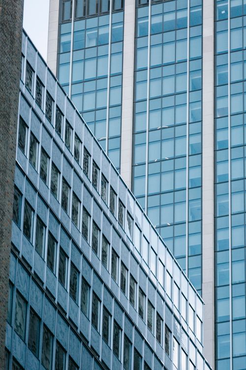 Free Low angle complex of contemporary buildings with glass mirrored windows in city downtown in daytime Stock Photo
