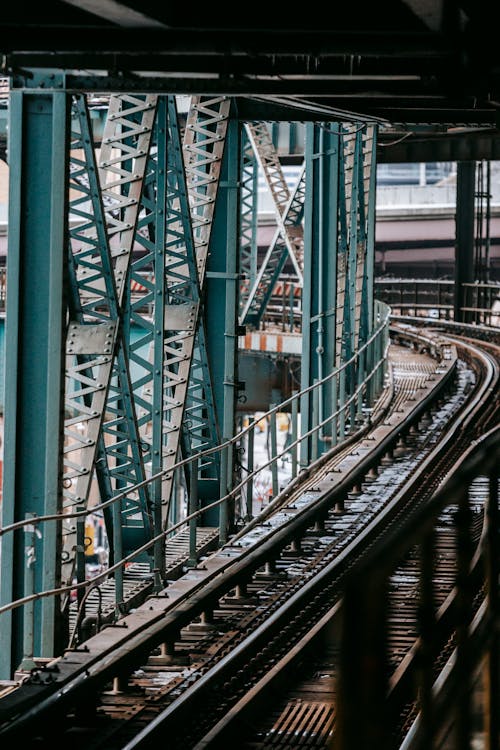 Massive metal constructions and railroad on modern Manhattan Bridge crossing river in New York City