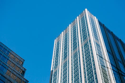 From below of contemporary multistory tall house under cloudless bright blue sky in daytime