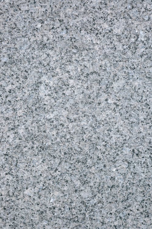 Top view of gray granite panel of local street of city in daytime