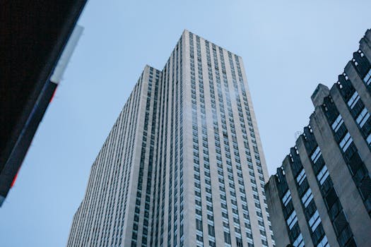 Low angle of exterior of modern skyscraper located in downtown of city in daylight