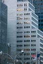 USA flag placed near high rise buildings located in center of city in daytime