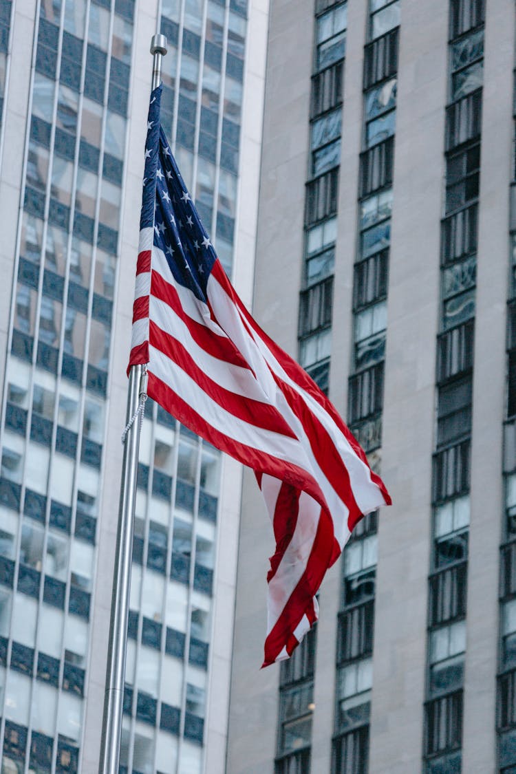 American Flag Waving Against Contemporary Skyscrapers