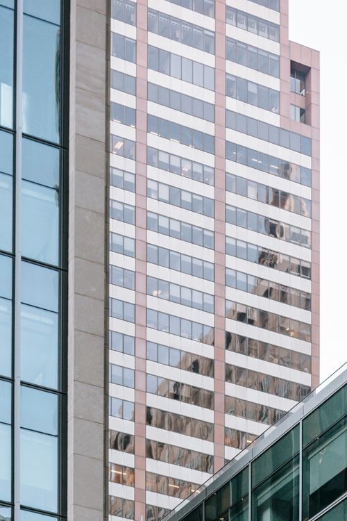 Free Creative design of contemporary tall building exterior reflecting sky and ornamental construction in city in daylight Stock Photo