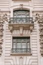 Aged masonry building exterior with fenced balconies and decorative beige walls in city in daylight