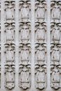 Backdrop of old gray stone wall with architectural decor in rows separated by vertical lines