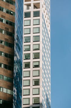 Creative design of contemporary high house exteriors with square shaped windows against blue sky in city