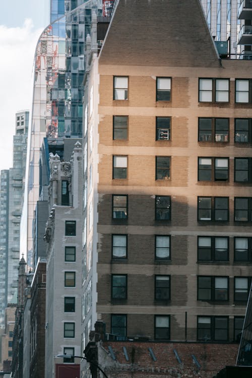 Tall brick building near modern tower