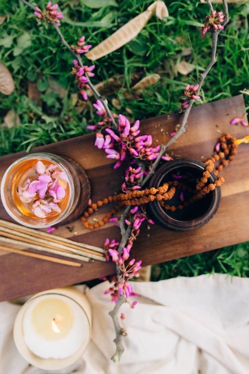 Free Top view of yoga setup with incense, beads, and flowers on grass, perfect for meditation imagery. Stock Photo