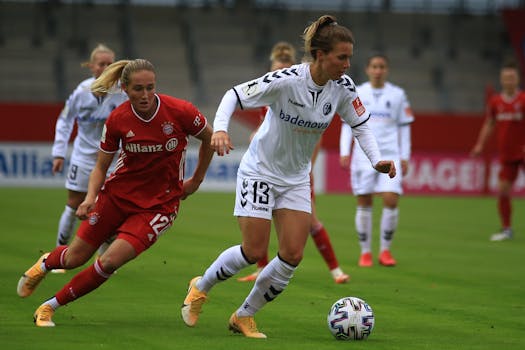 Action shot of women soccer players competing in an outdoor match, showcasing skill and determination.