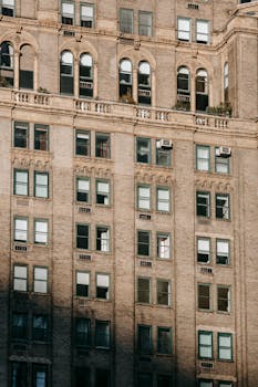 A detailed view of a historic multistory building facade with classic arched windows.