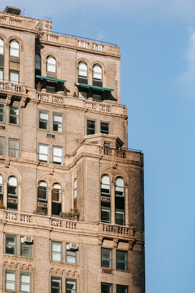 Facade Of Old Residential Building Against Blue Sky