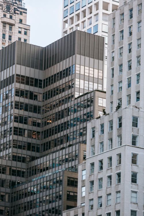 Free Low angle of modern multistory tower with high apartment building located on street of city Stock Photo