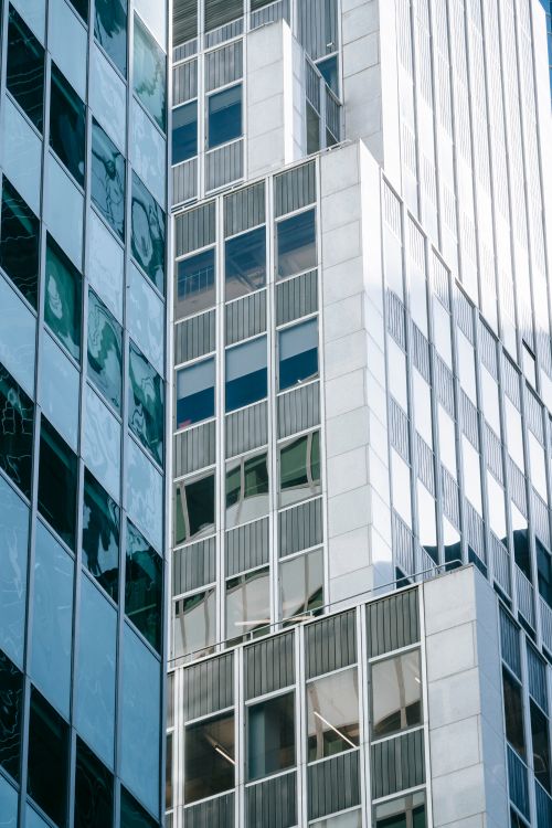 Free Contemporary high rise business center with glass walls located on street in financial district of modern city with bright sunlight Stock Photo