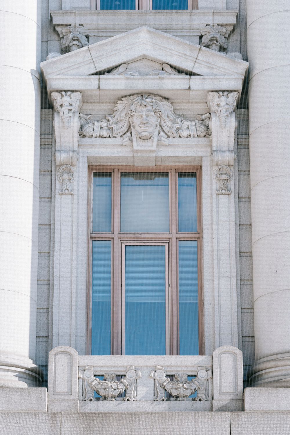 Ornamental columns and elements around window · Free Stock Photo
