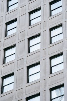 High-angle view of a modern building facade with reflective windows showcasing clean architecture.