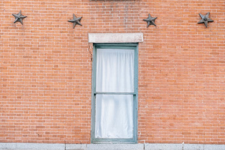 Brick Wall With Window And Star Shaped Decoration