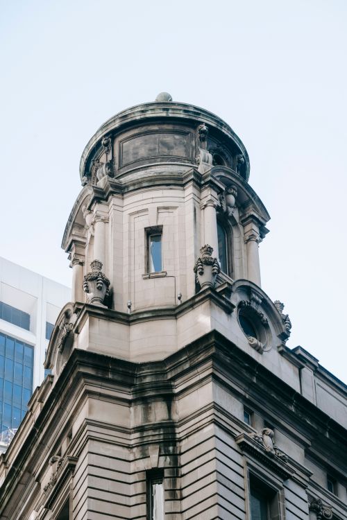 Free From below exterior of old stone building with classical architecture style with dome and ornamental elements on urban street Stock Photo
