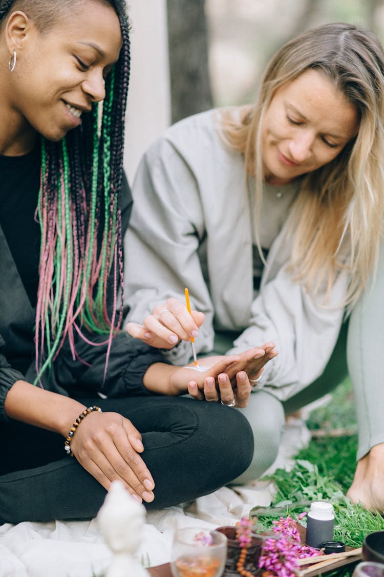 A Woman Painting Another Woman's Palm