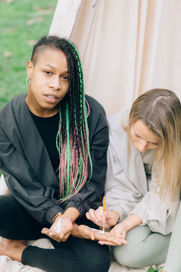 Woman Painting Her Friend's Palm