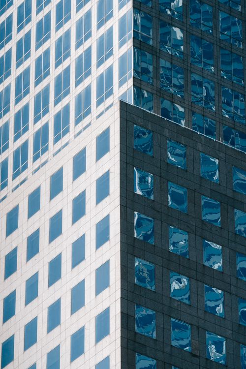 Modern city building with mirrored windows · Free Stock Photo