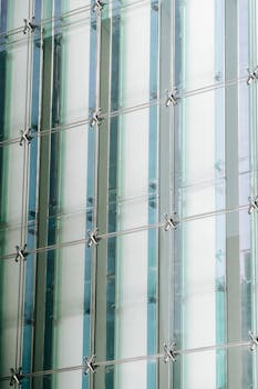 Close-up view of a sleek glass facade on a contemporary urban structure.