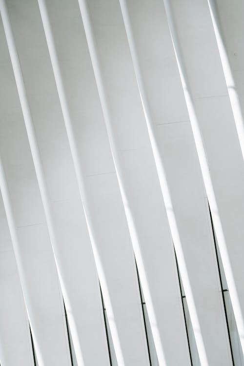 Textured white ribs of facade of modern building of metro terminal with windows as abstract background