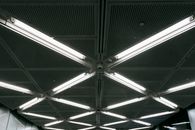 Metal ceiling with glowing lamps in underground garage