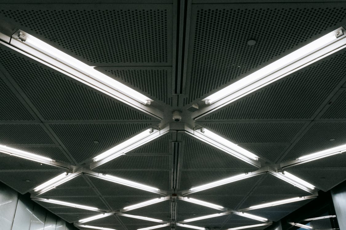 Free Metal ceiling with glowing lamps in underground garage Stock Photo